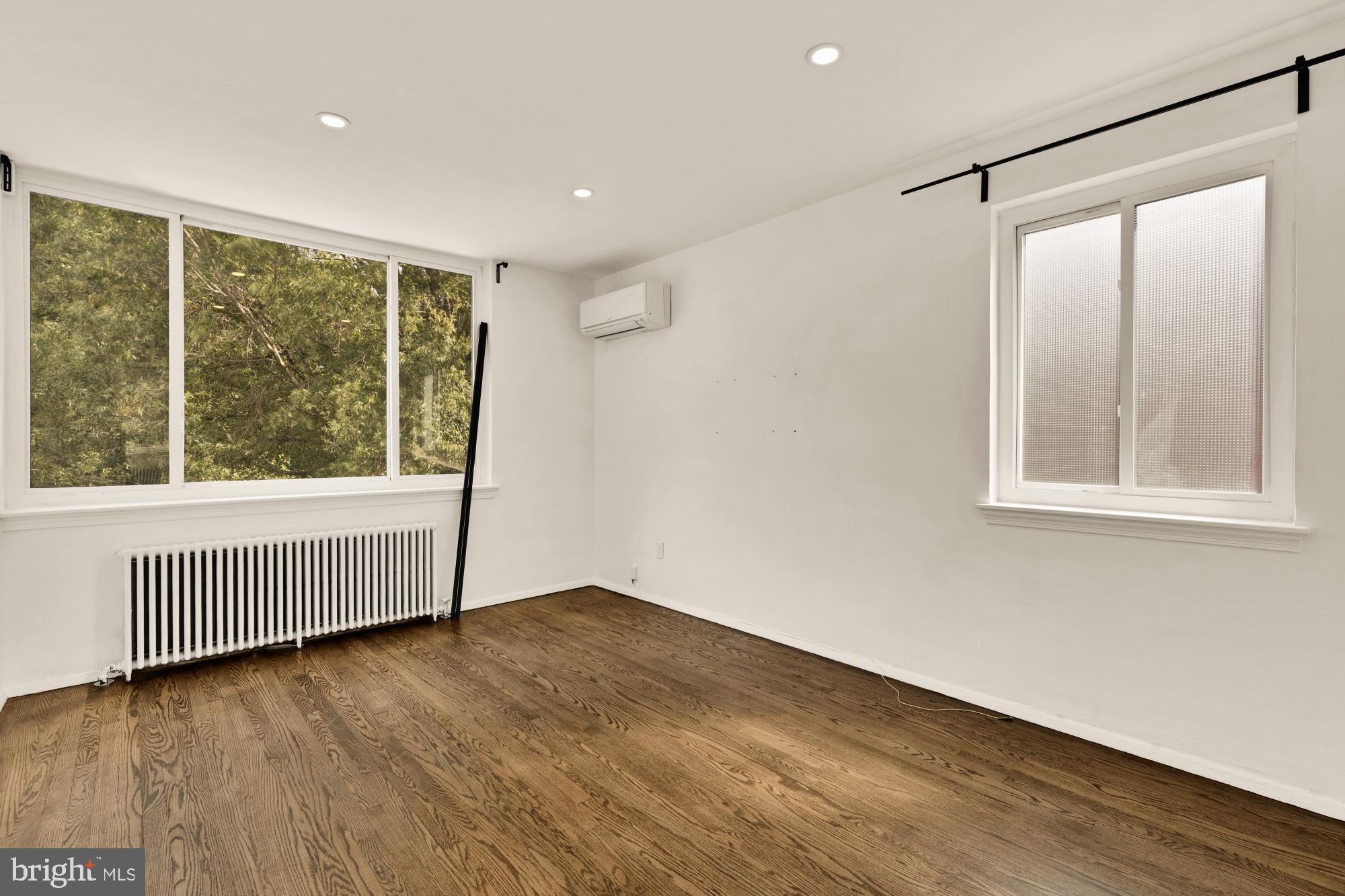 215 Hawaii Avenue Northeast Washington, DC 20011 - Photo 33 of 45 a view of an empty room with wooden floor and a window
