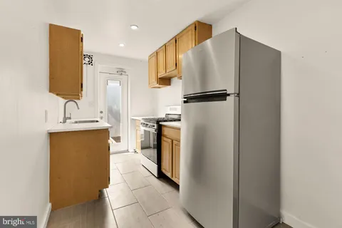 a view of an empty room with wooden floor and closet