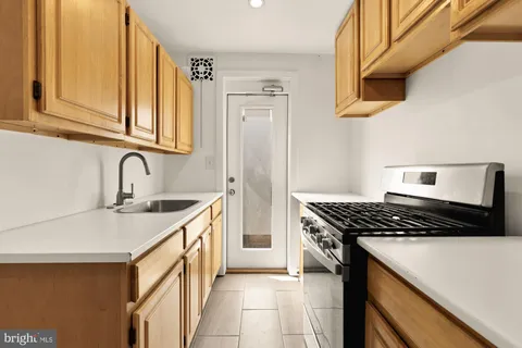 a kitchen with stainless steel appliances a refrigerator and a sink