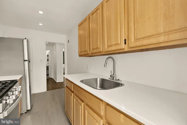 a kitchen with stainless steel appliances granite countertop a stove a sink and a refrigerator