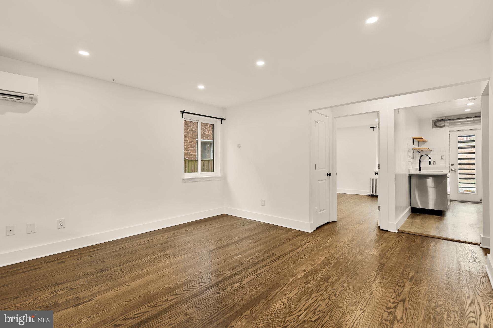 215 Hawaii Avenue Northeast Washington, DC 20011 - Photo 7 of 45 a view of a big room with wooden floor and windows