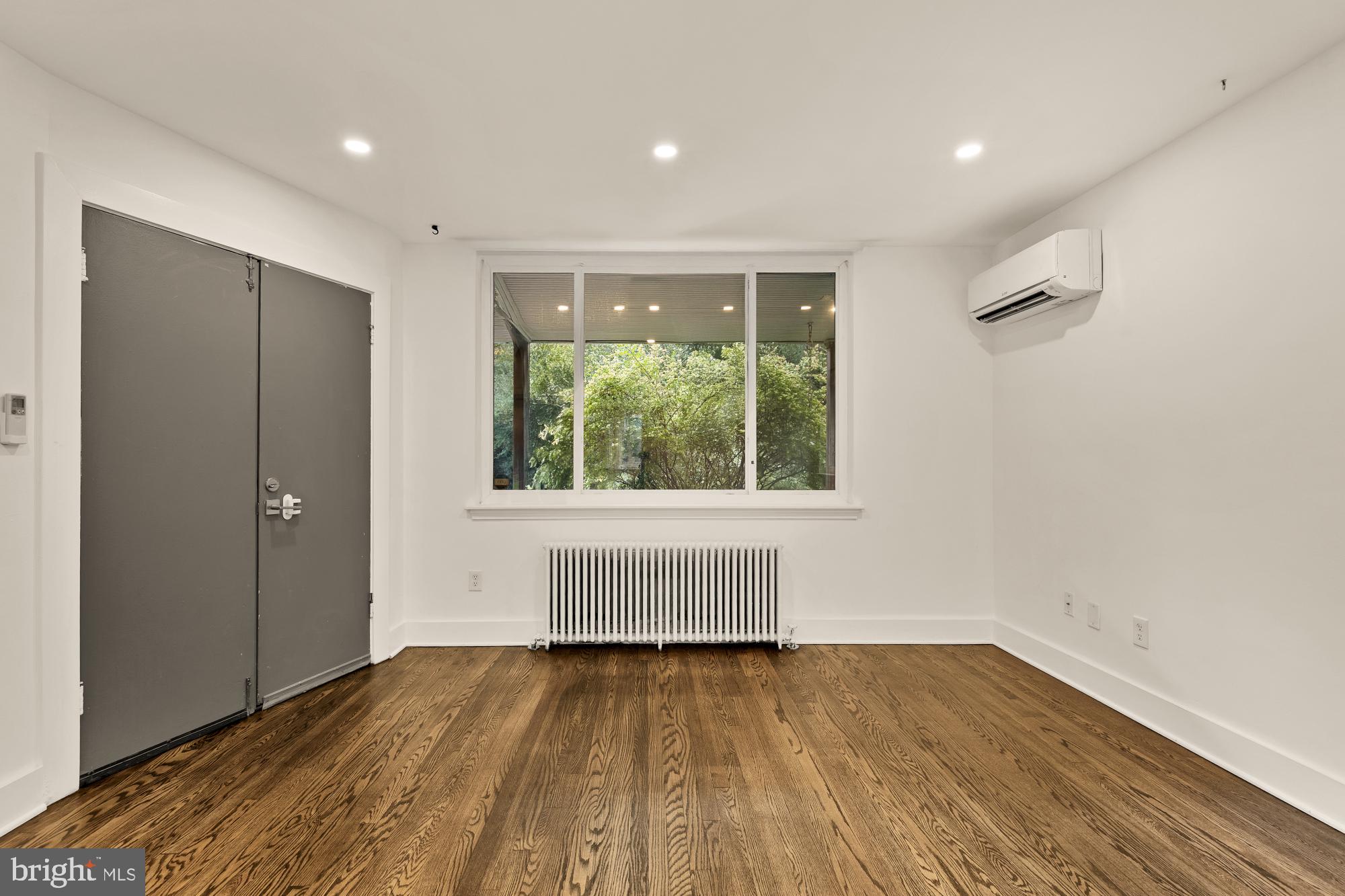 215 Hawaii Avenue Northeast Washington, DC 20011 - Photo 10 of 45 a view of an empty room with wooden floor and a window