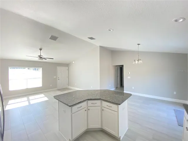a kitchen with granite countertop a stove and a sink