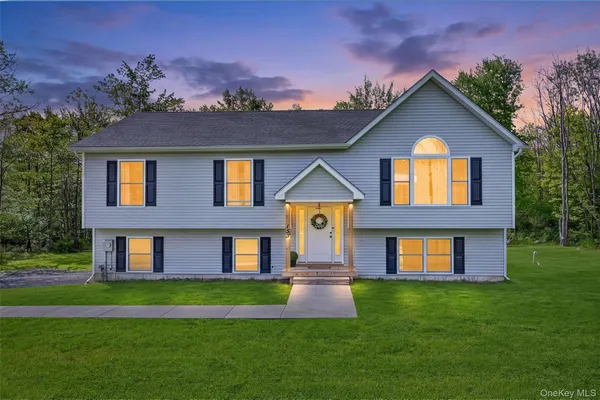 a front view of a house with a yard and garage