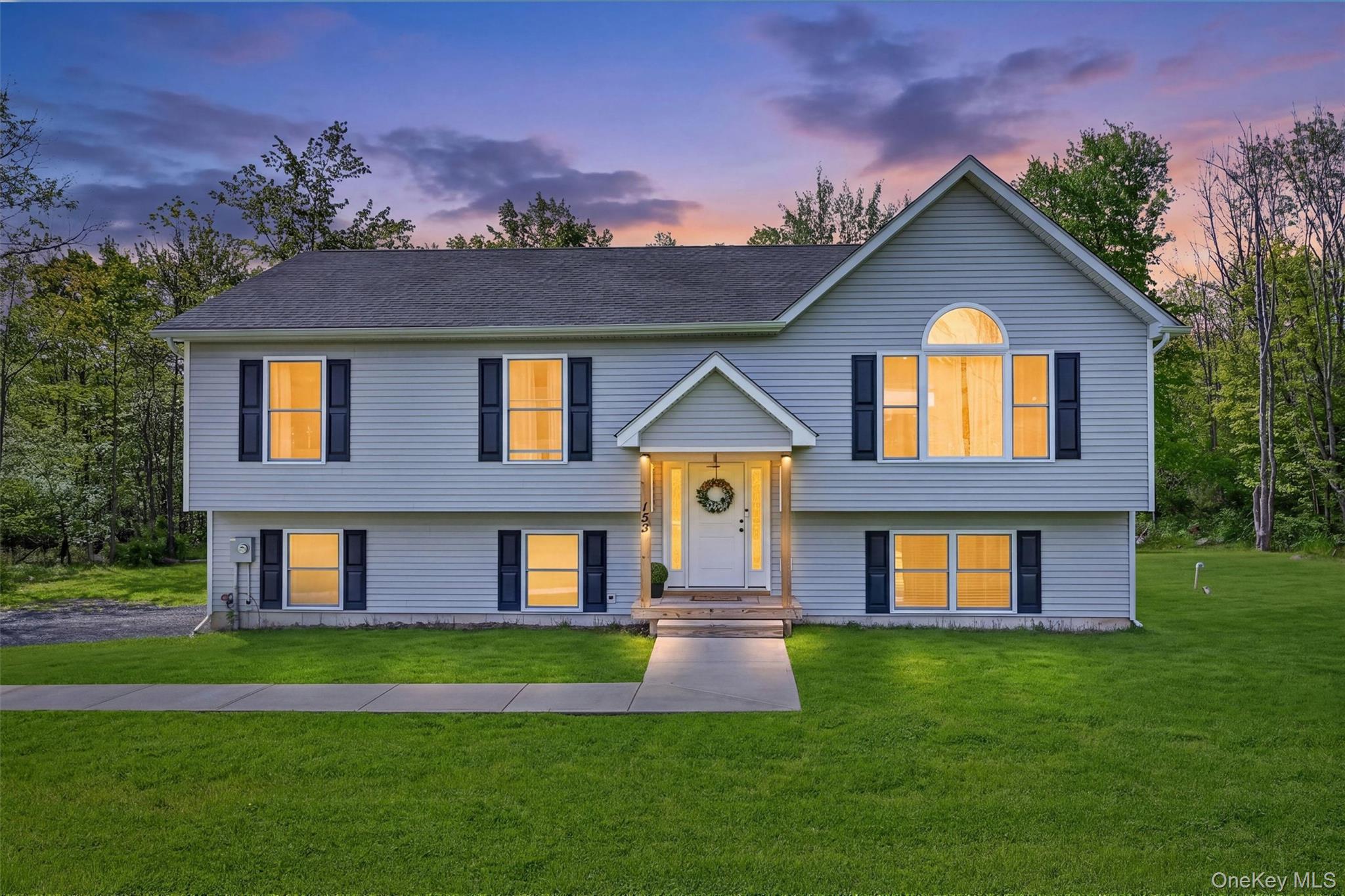153 Ridge Drive Middletown, NY 10940 - Photo 1 of 47 a front view of a house with a yard and garage