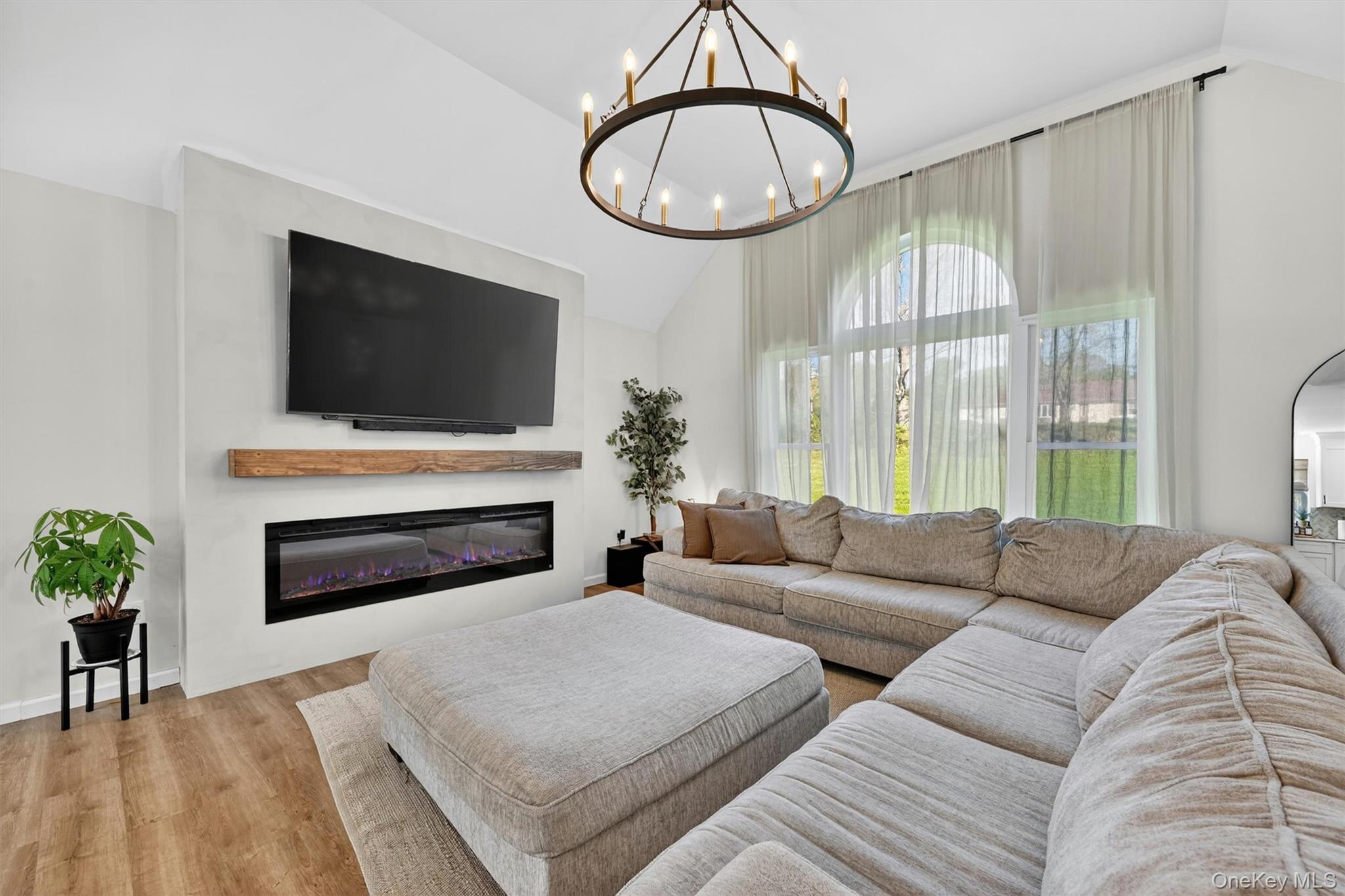 153 Ridge Drive Middletown, NY 10940 - Photo 11 of 47 a living room with furniture a fireplace and a flat screen tv