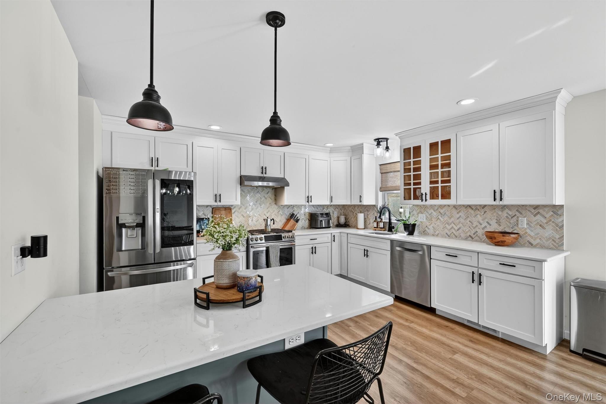 153 Ridge Drive Middletown, NY 10940 - Photo 18 of 47 a kitchen with white cabinets and stainless steel appliances