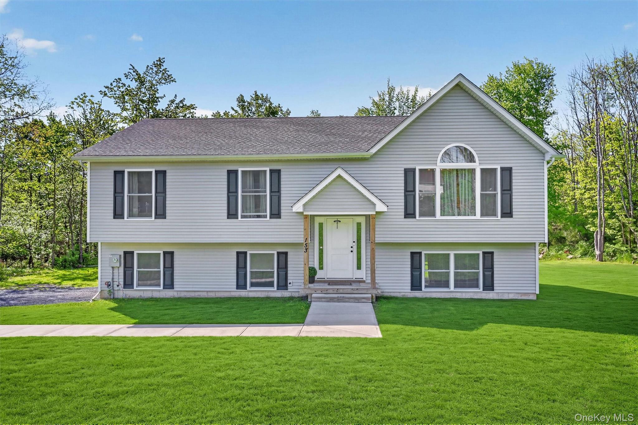 153 Ridge Drive Middletown, NY 10940 - Photo 2 of 47 a front view of a house with a yard