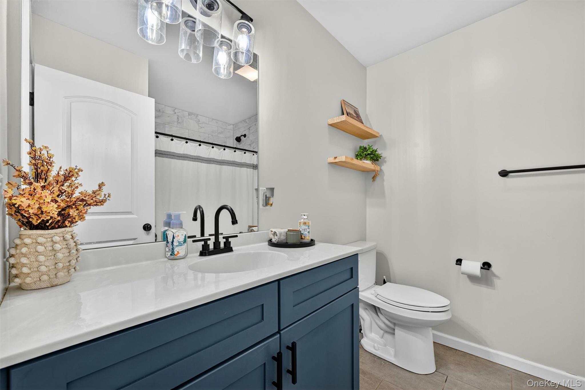 153 Ridge Drive Middletown, NY 10940 - Photo 22 of 47 a bathroom with a granite countertop sink a toilet and mirror