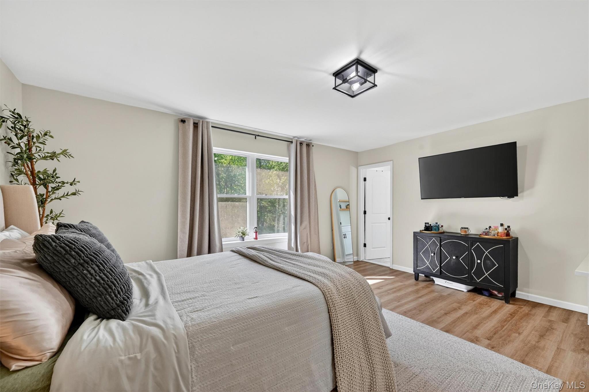 153 Ridge Drive Middletown, NY 10940 - Photo 25 of 47 a bedroom with a bed and a flat screen tv