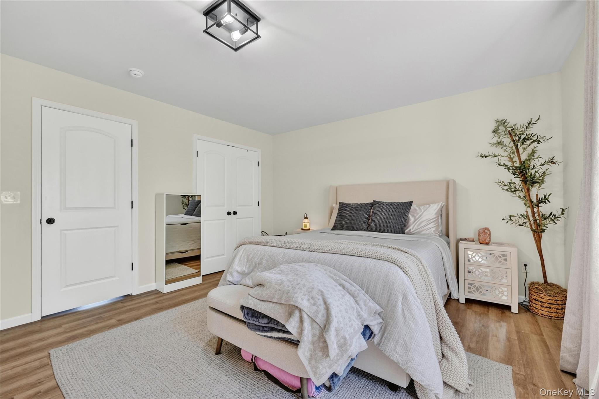 153 Ridge Drive Middletown, NY 10940 - Photo 26 of 47 a spacious bedroom with a bed and a chandelier
