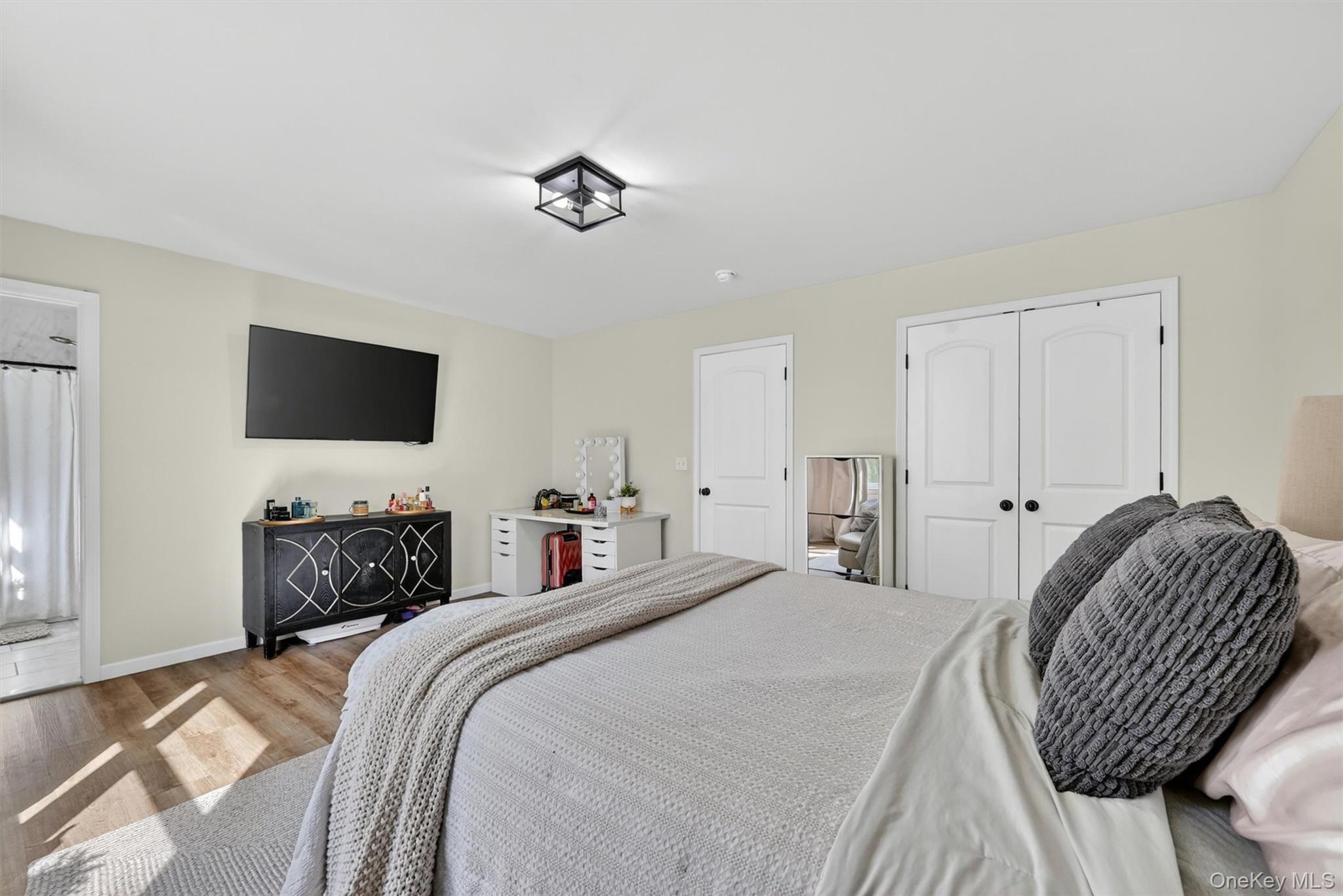 153 Ridge Drive Middletown, NY 10940 - Photo 27 of 47 a bedroom with a bed and a flat screen tv
