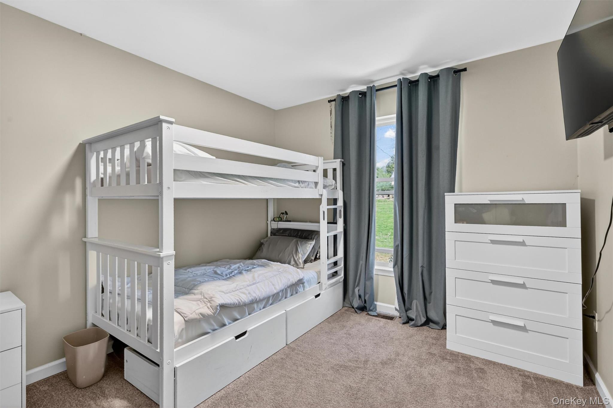 153 Ridge Drive Middletown, NY 10940 - Photo 31 of 47 a bedroom with a bed and flat screen tv