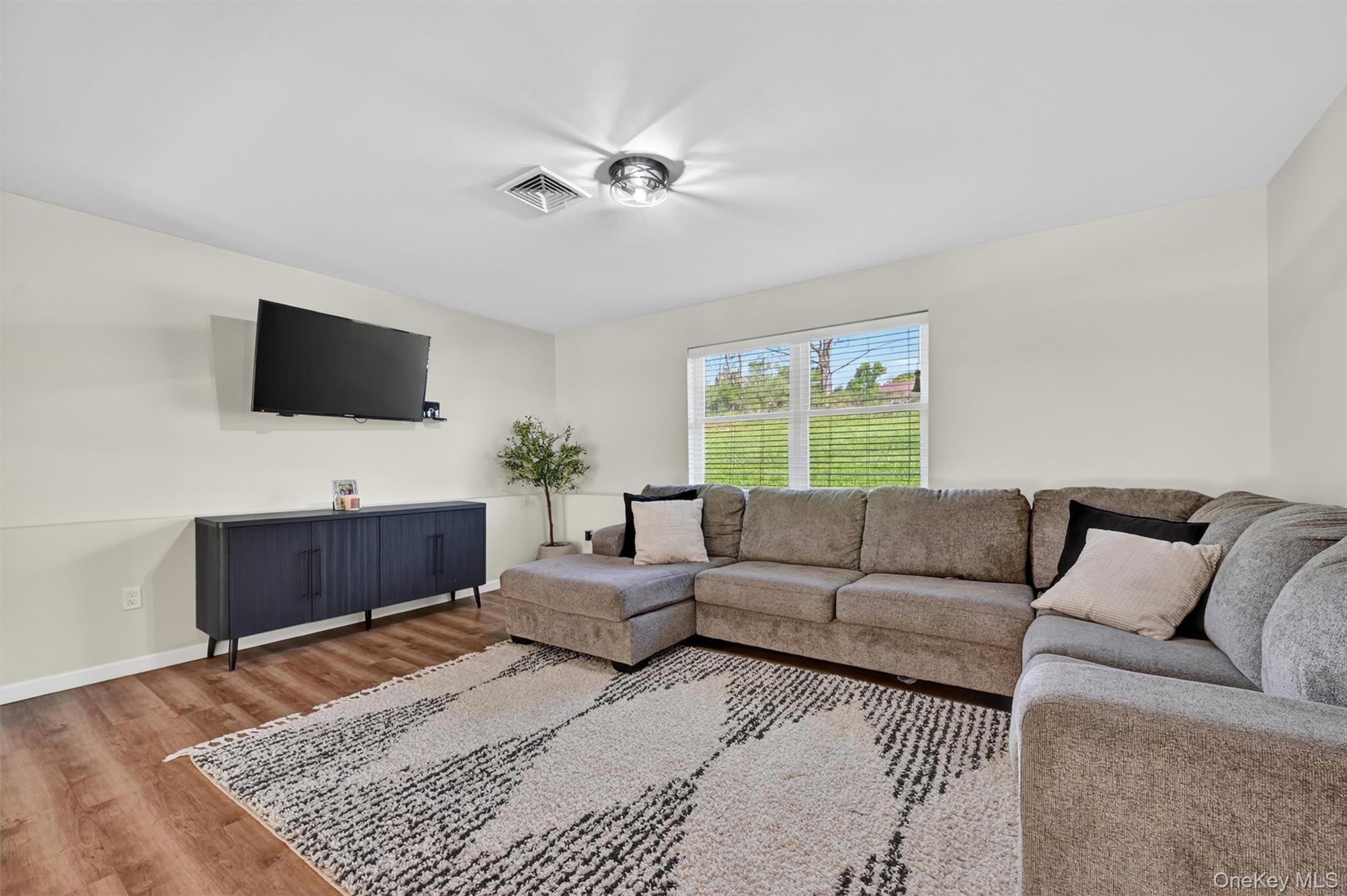 153 Ridge Drive Middletown, NY 10940 - Photo 34 of 47 a living room with furniture and a flat screen tv