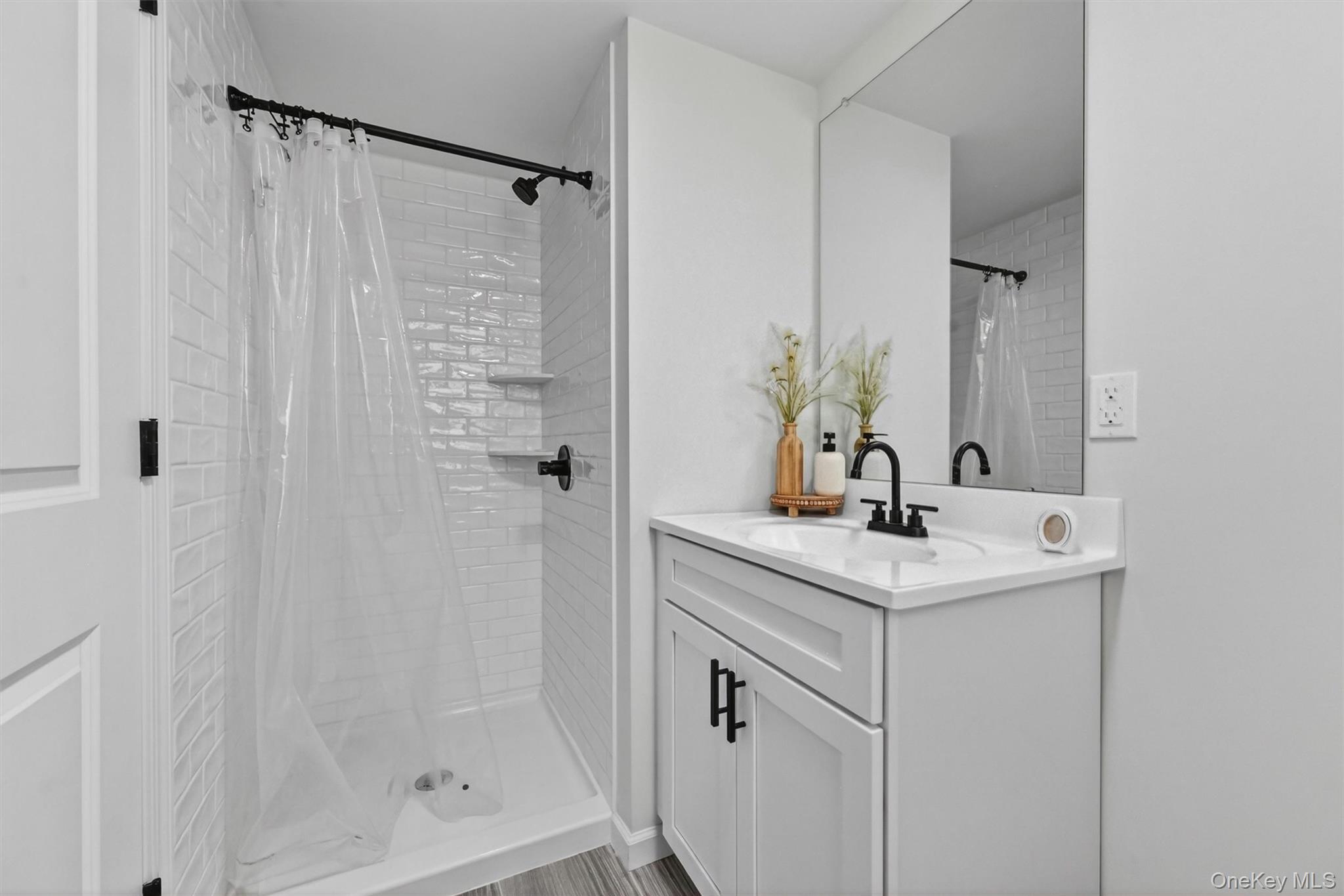 153 Ridge Drive Middletown, NY 10940 - Photo 40 of 47 a bathroom with a sink a mirror and shower