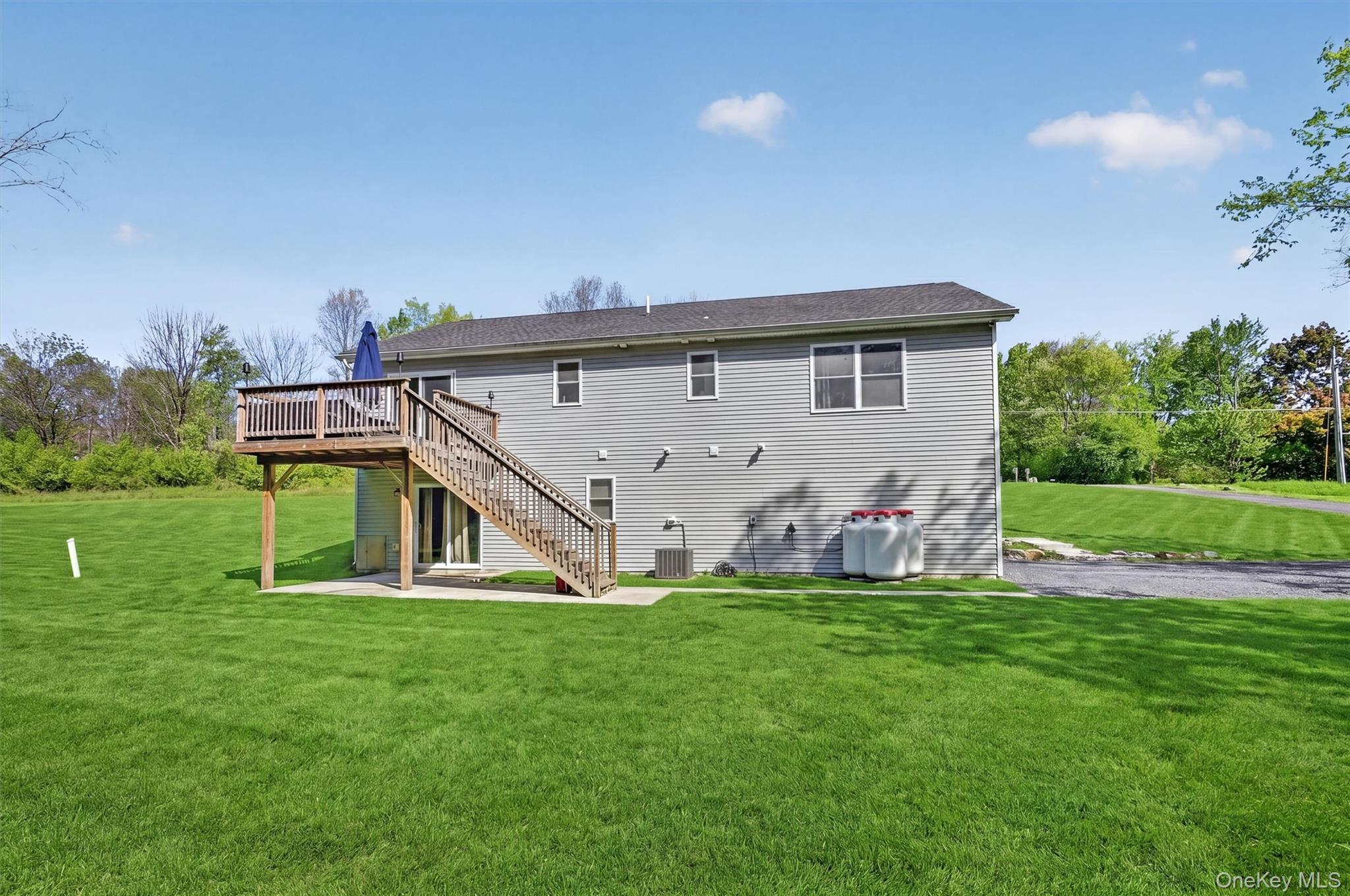 153 Ridge Drive Middletown, NY 10940 - Photo 4 of 47 a view of a house with a big yard and potted plants