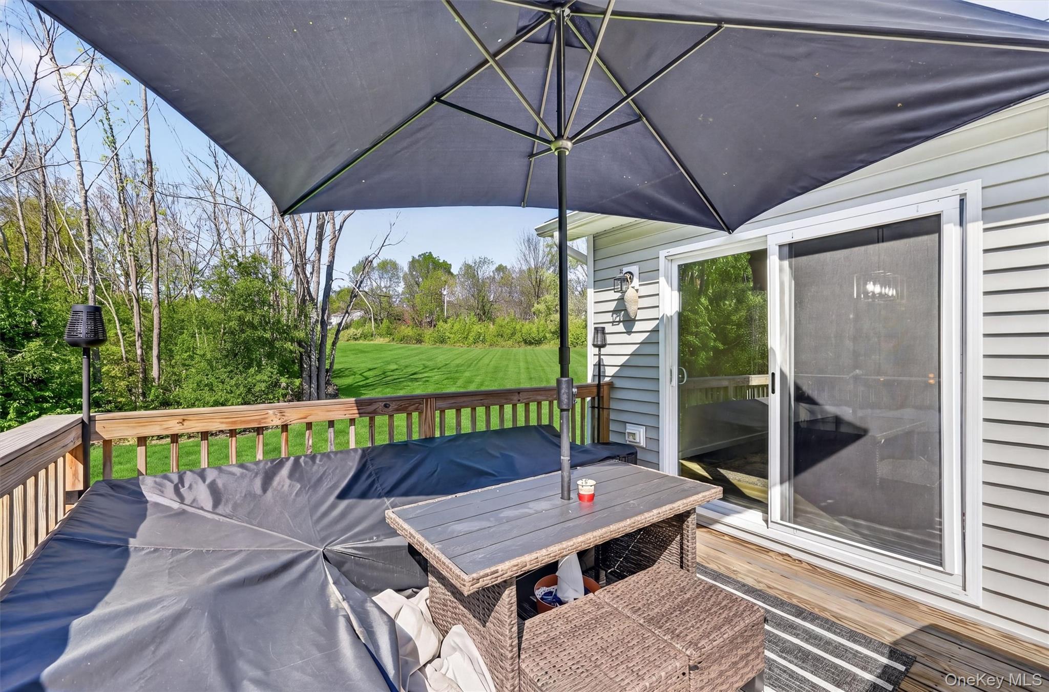 153 Ridge Drive Middletown, NY 10940 - Photo 43 of 47 a view of a balcony with furniture and umbrella