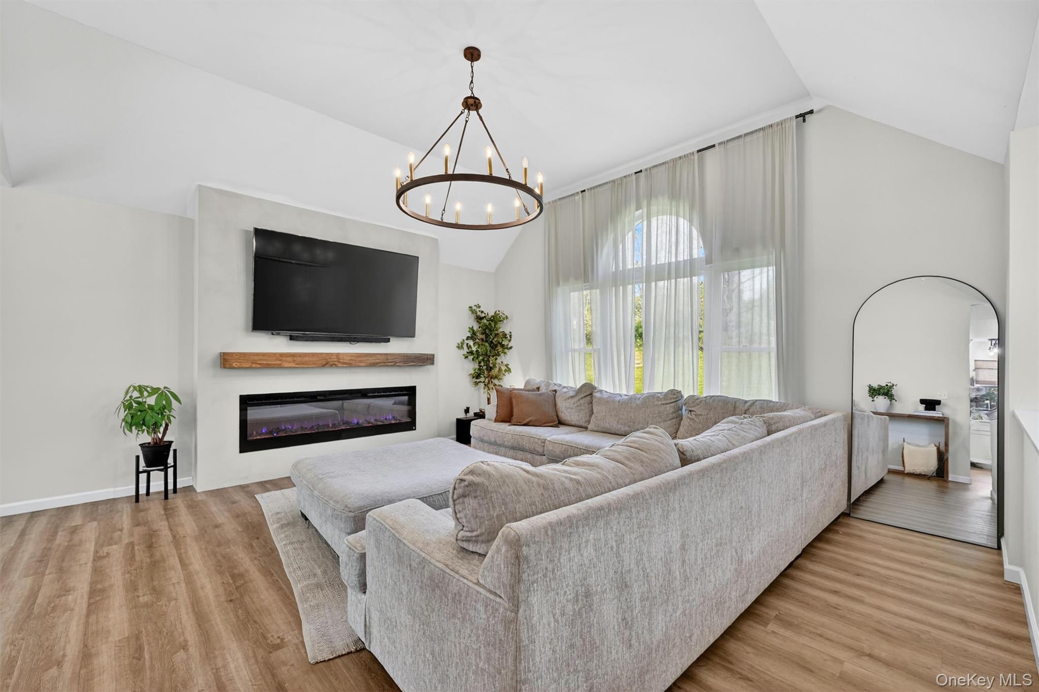 153 Ridge Drive Middletown, NY 10940 - Photo 10 of 47 a living room with furniture a fireplace and a flat screen tv