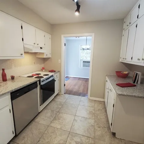 a kitchen with stainless steel appliances granite countertop a sink and cabinets