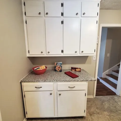 a kitchen with cabinets appliances and a counter top
