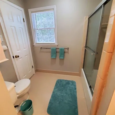 view of bathroom with a tub and a toilet
