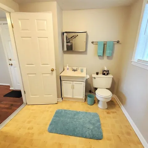 a bathroom with a toilet a sink and a shower