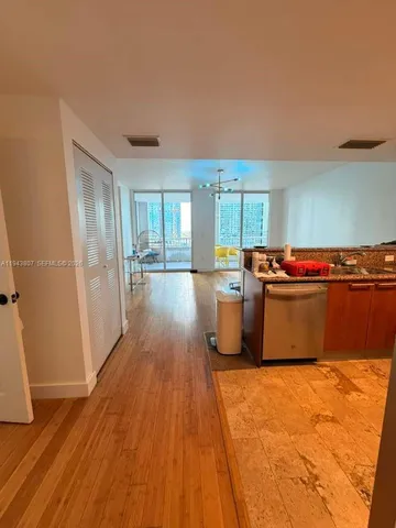 a kitchen with granite countertop a stove and a wooden floors
