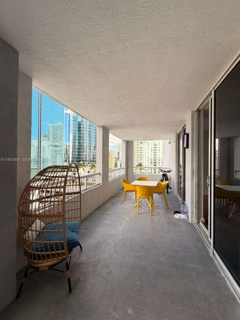 170 Southeast 14th Street, Unit 1807 Miami, FL 33131 - Photo 8 of 11 a bedroom with furniture and a window