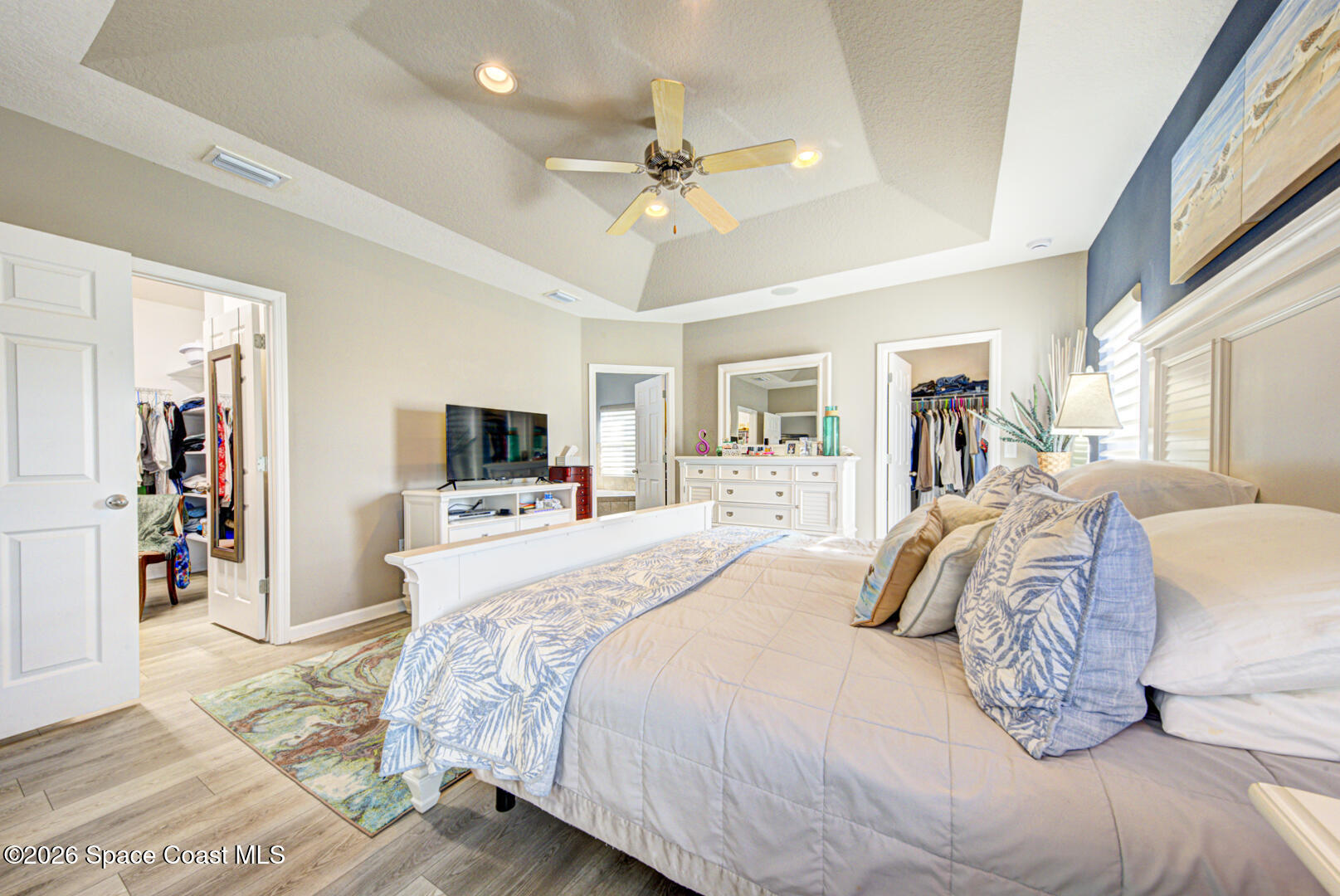 2975 Louetta Circle Melbourne, FL 32901 - Photo 18 of 44 a bedroom with a large bed and a tv