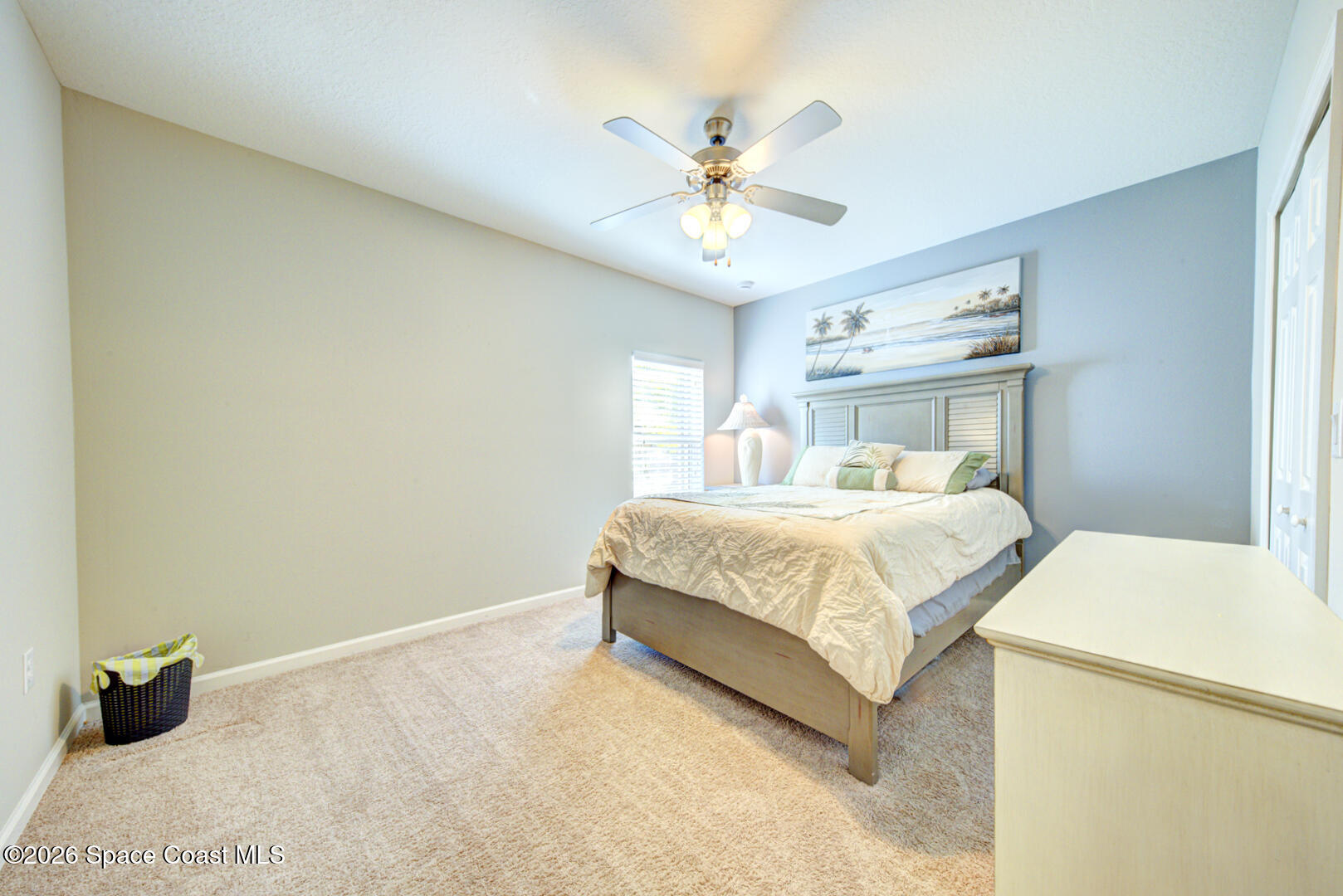 2975 Louetta Circle Melbourne, FL 32901 - Photo 24 of 44 a bedroom with a bed and a chandelier