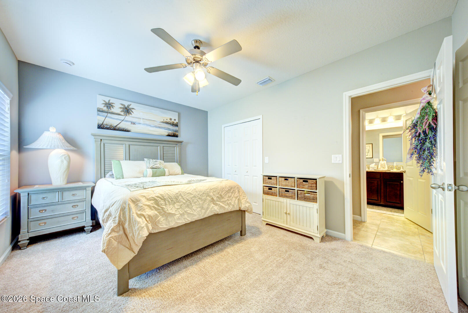 2975 Louetta Circle Melbourne, FL 32901 - Photo 25 of 44 a bedroom with a bed and a chandelier