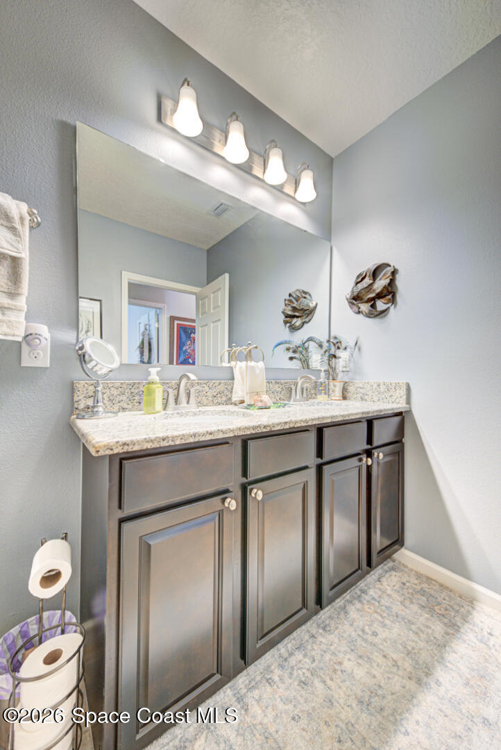 2975 Louetta Circle Melbourne, FL 32901 - Photo 28 of 44 a bathroom with a sink and a mirror
