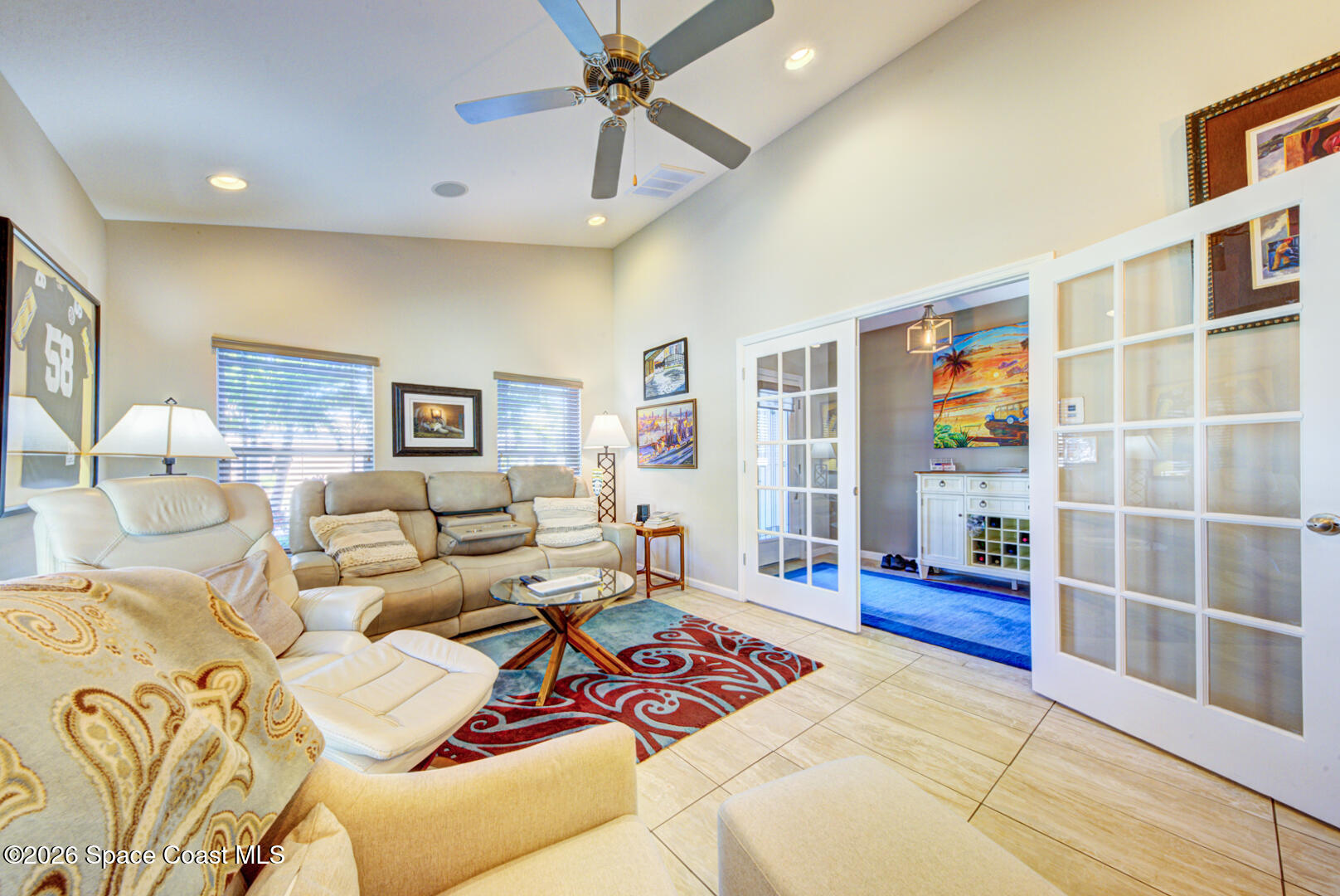 2975 Louetta Circle Melbourne, FL 32901 - Photo 32 of 44 a living room with furniture a rug and a chandelier