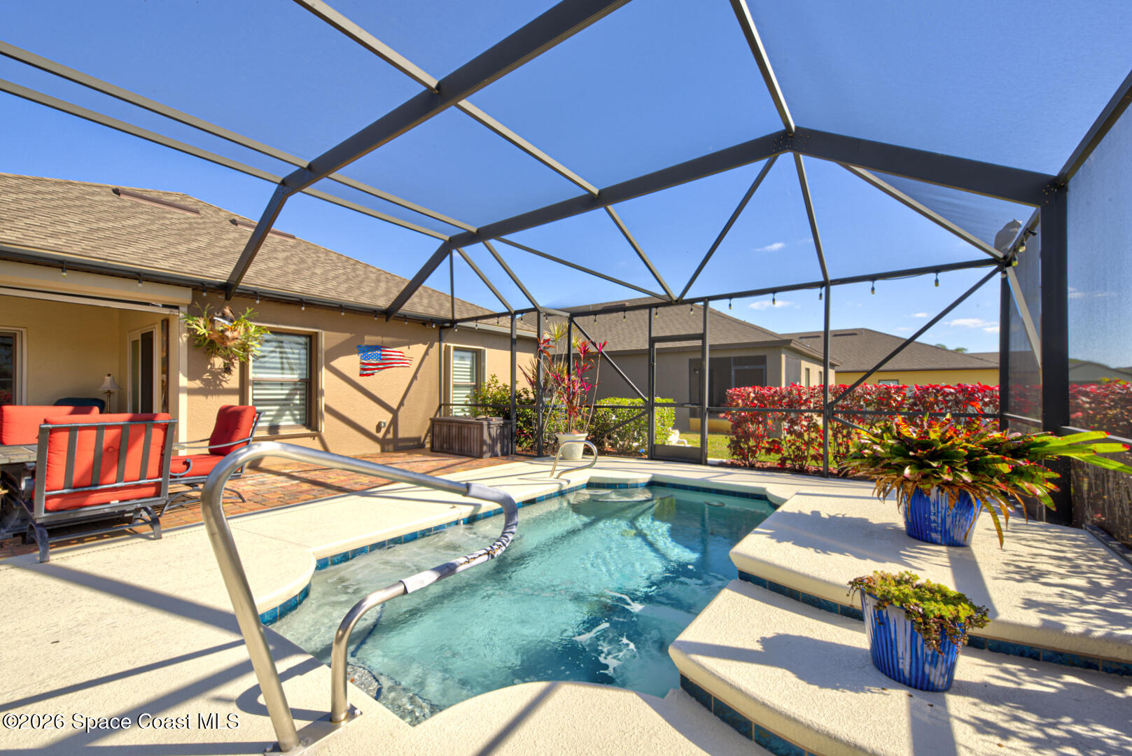 2975 Louetta Circle Melbourne, FL 32901 - Photo 40 of 44 a view of a backyard with table and chairs under an umbrella