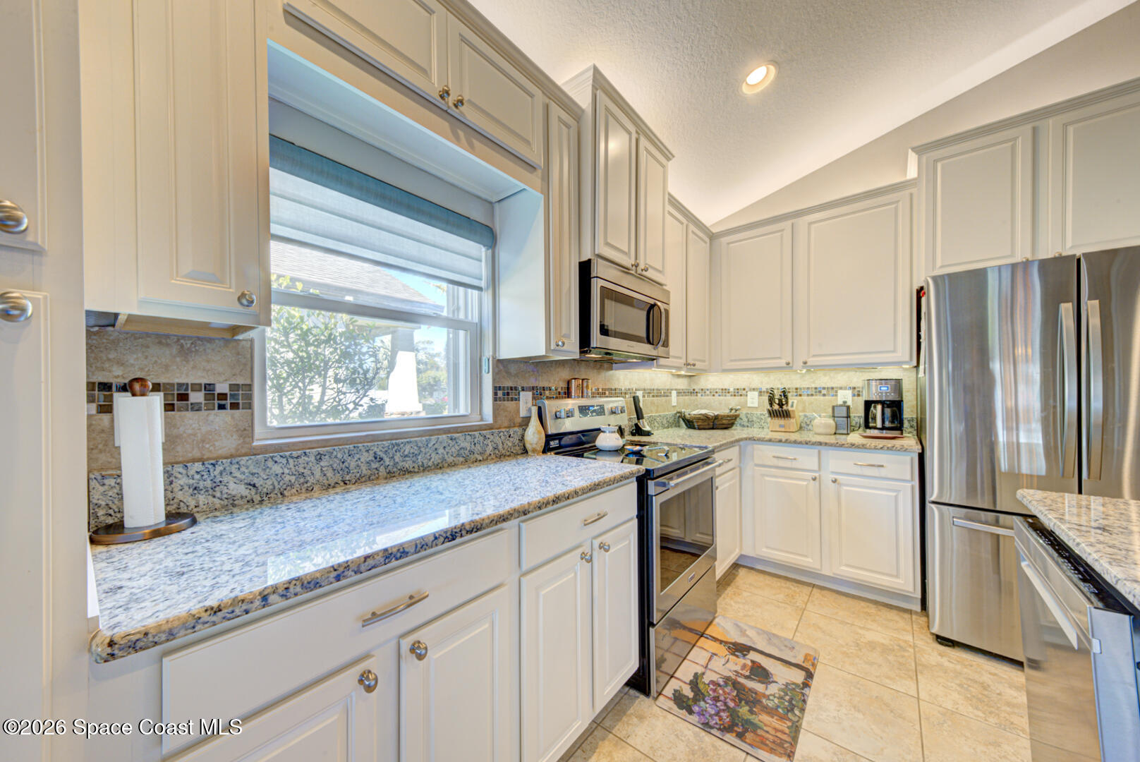 2975 Louetta Circle Melbourne, FL 32901 - Photo 6 of 44 a kitchen with granite countertop a sink stainless steel appliances and window