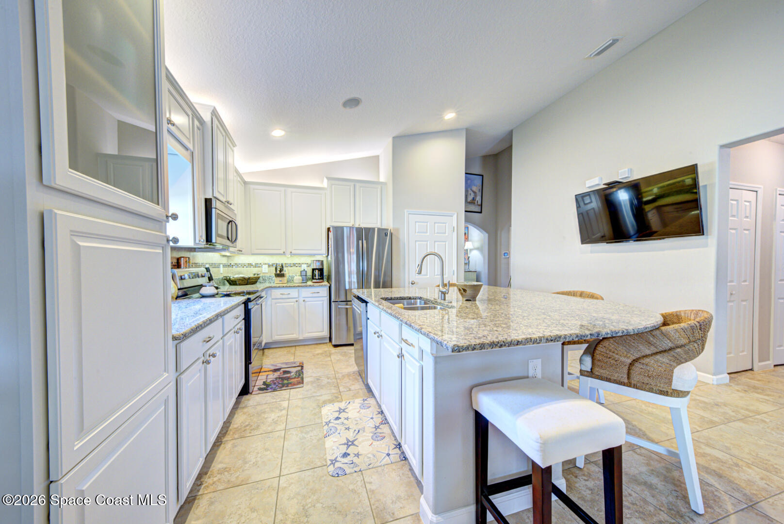 2975 Louetta Circle Melbourne, FL 32901 - Photo 7 of 44 a kitchen with kitchen island granite countertop a sink and counter space