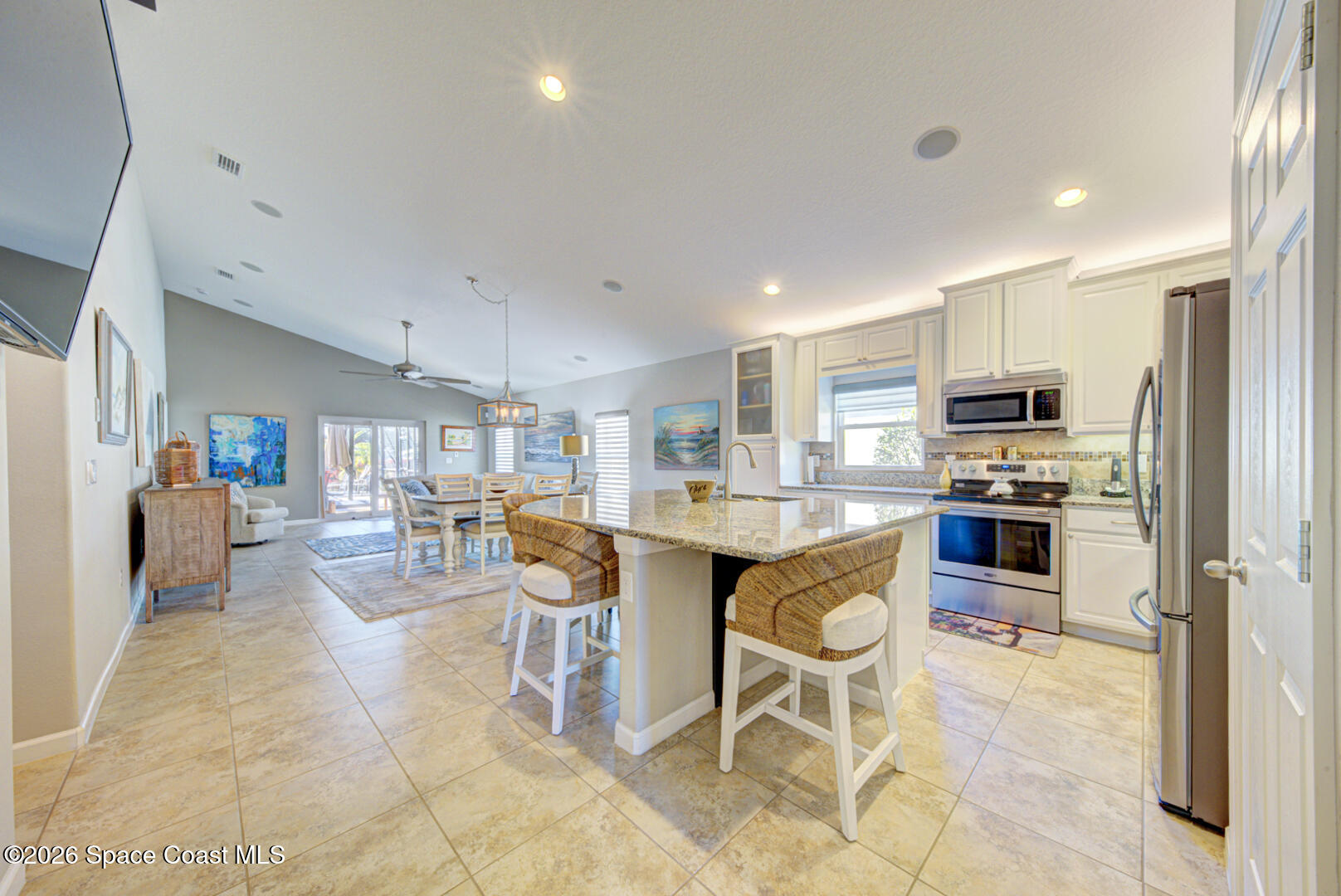 2975 Louetta Circle Melbourne, FL 32901 - Photo 9 of 44 a kitchen with stainless steel appliances a stove a sink a oven a dining table and chairs