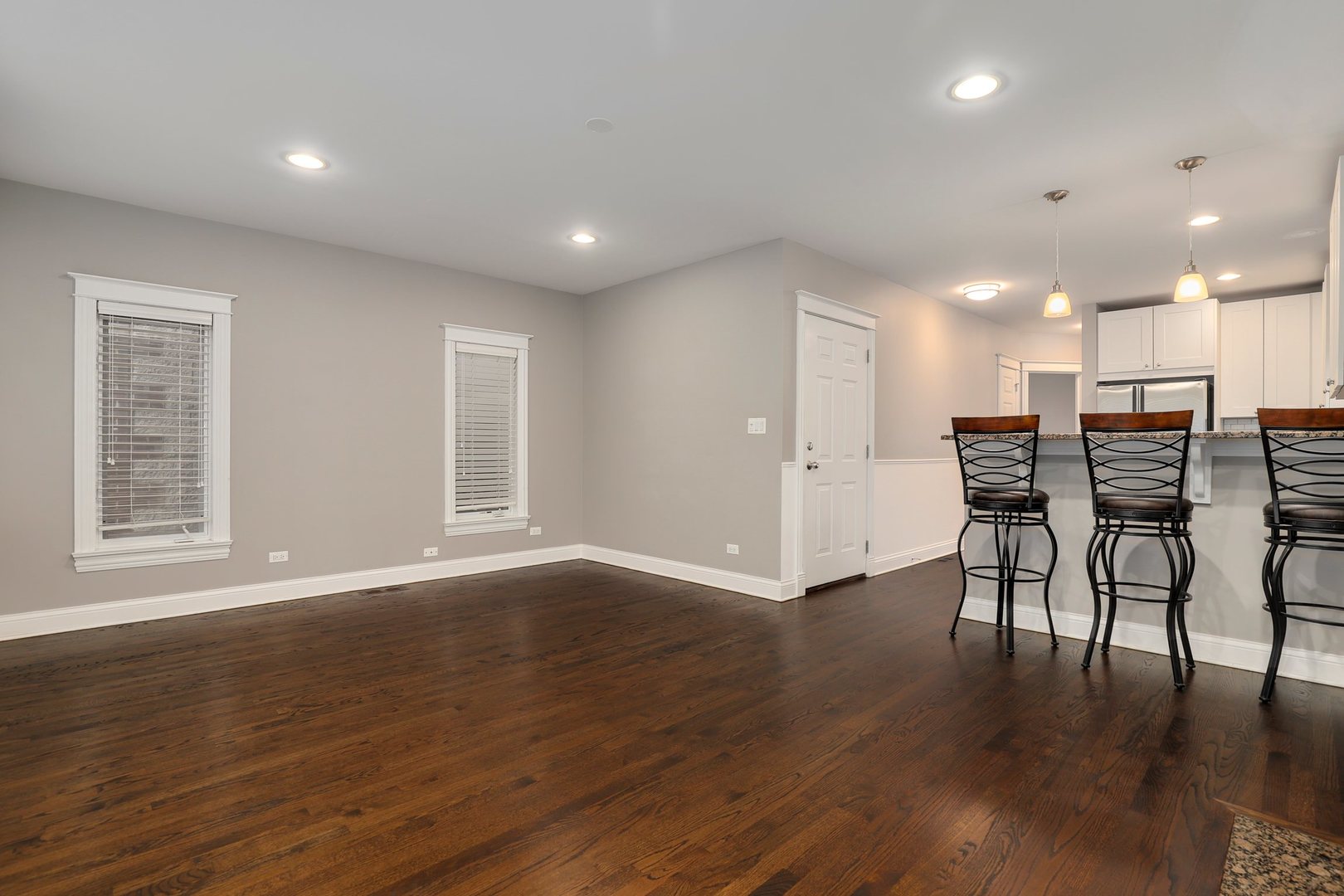 3211 North Racine Avenue, Unit 2 Chicago, IL 60657 - Photo 7 of 22 an empty room with wooden floor and windows