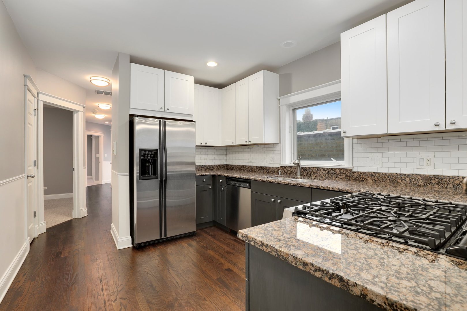 3211 North Racine Avenue, Unit 2 Chicago, IL 60657 - Photo 9 of 22 a kitchen with granite countertop a stove and a refrigerator