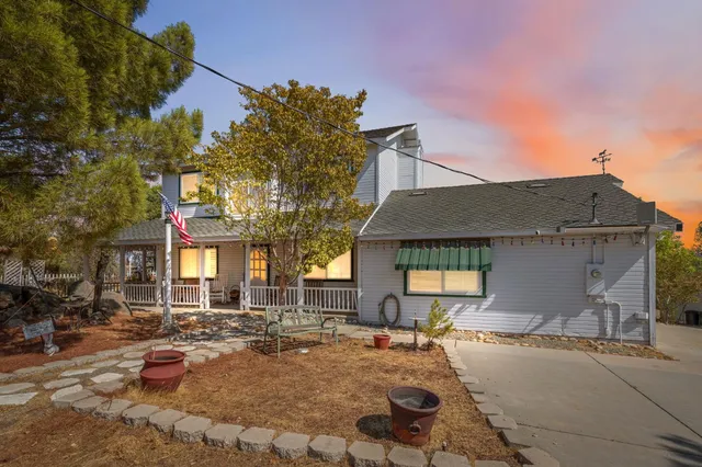 a view of a house with snow on the road
