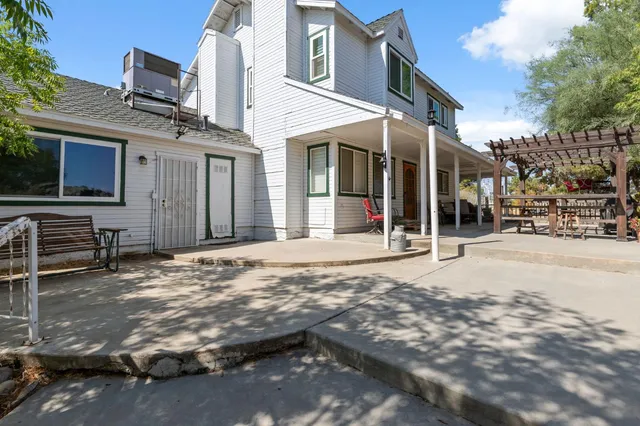 a view of a house with a yard covered in snow