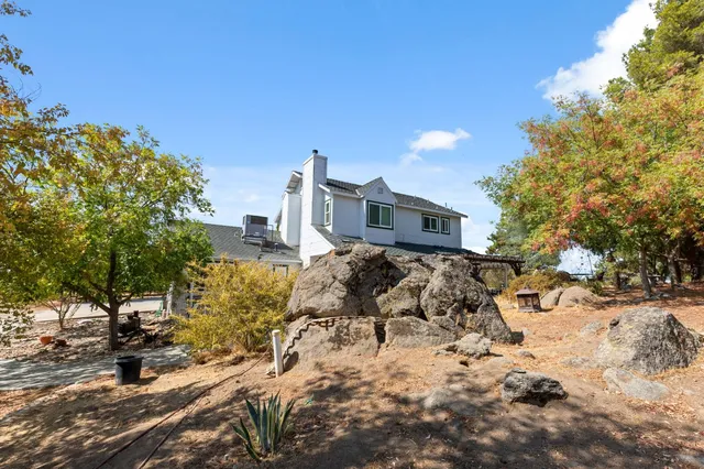 a view of a chairs and table in the backyard