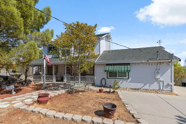 a backyard of a house with fire pit and outdoor seating