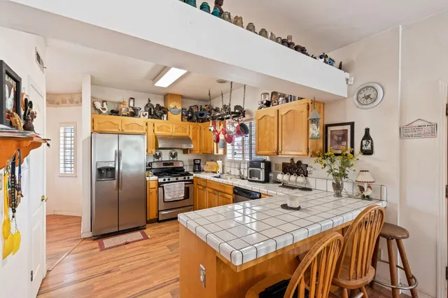 a large kitchen with stainless steel appliances lots of counter space and a sink