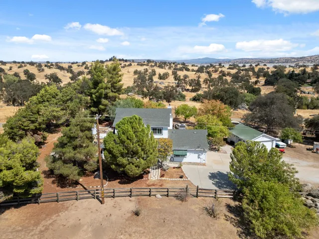 an aerial view of ocean and residential houses with outdoor space