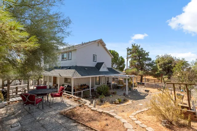 a view of a house with yard and sitting area