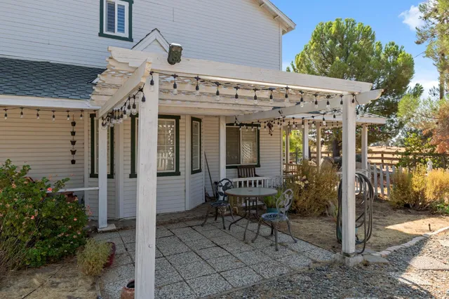a view of a patio with table and chairs and potted plants
