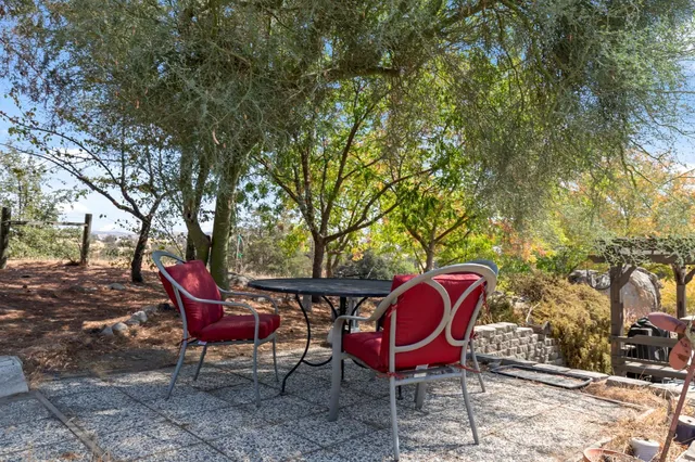 a view of a backyard with sitting area