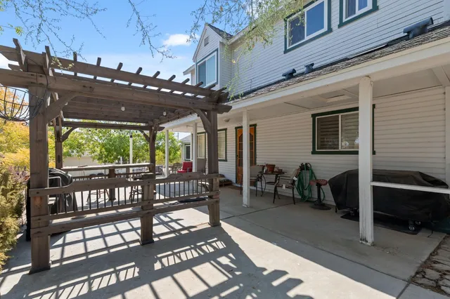 a view of a patio with a table and chairs