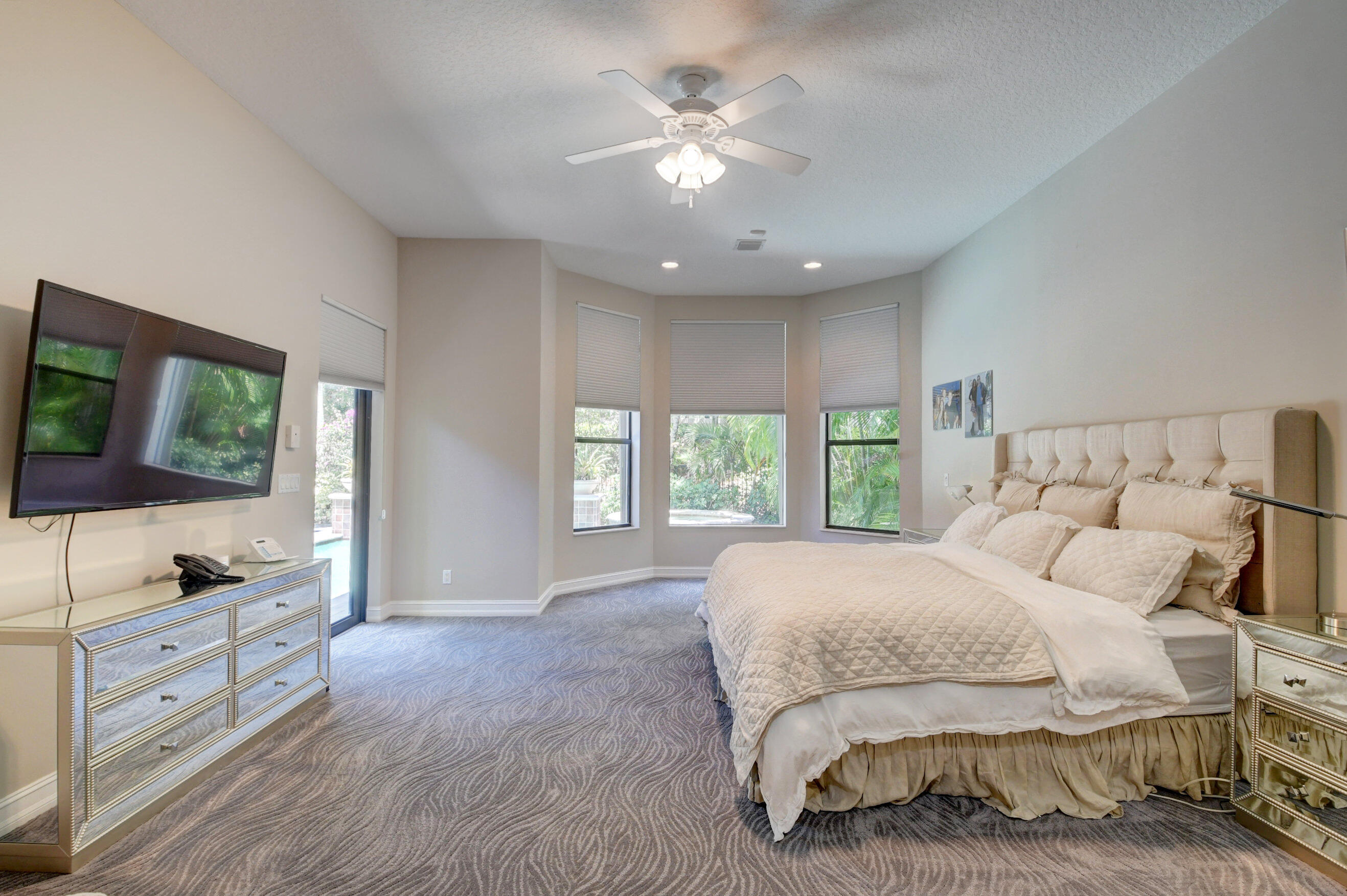 17798 Cadena Drive Boca Raton, FL 33496 - Photo 16 of 49 a spacious bedroom with a bed and a flat screen tv